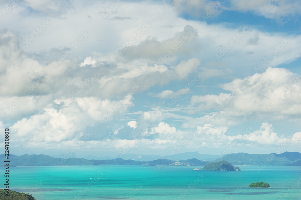 Seascape of phuket island..Tropical island in andaman blue sea with fluffy cloudy blue sky and sunlight..