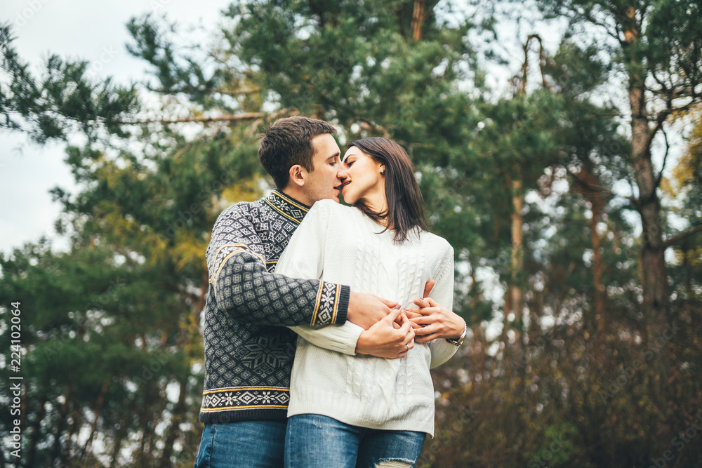 Fototapeta premium Pretty young couple walking together in the forest.