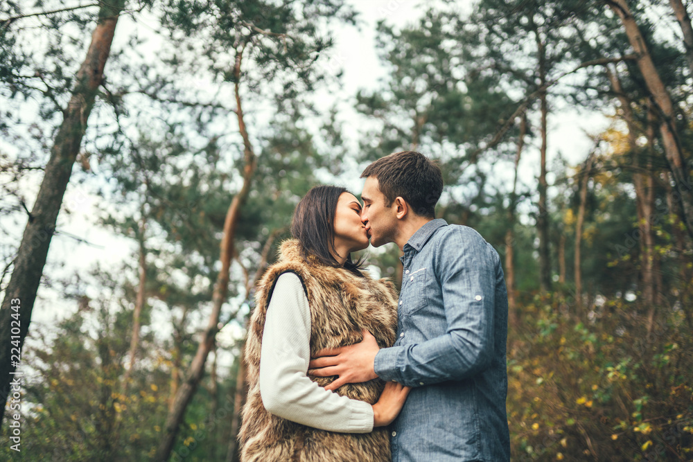Pretty young couple walking together in the forest. Pretty young couple walking together in the forest.