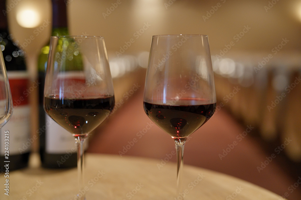 Glasses of red wine set on table in winery