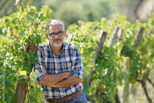Winemaker standing in vineyard
