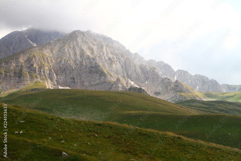Fototapeta premium Top of the mountain in the clouds, high summit in the sky - photo of nature