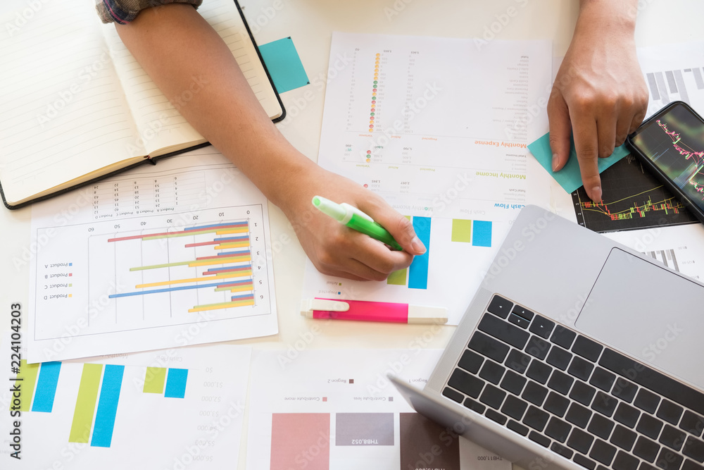 analytics financial data with top view hand of business working with paper chart. analytics financial data with top view hand of business working with paper chart.