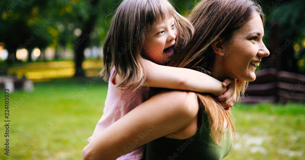 Little girl with special needs enjoy spending time with mother Little girl with special needs enjoy spending time with mother