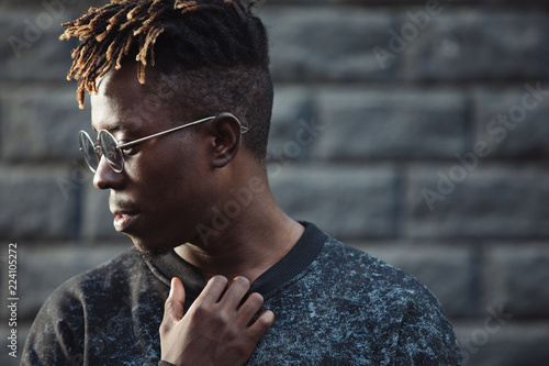 African man with dreadlocks hairstyle wearing modern glasses photo