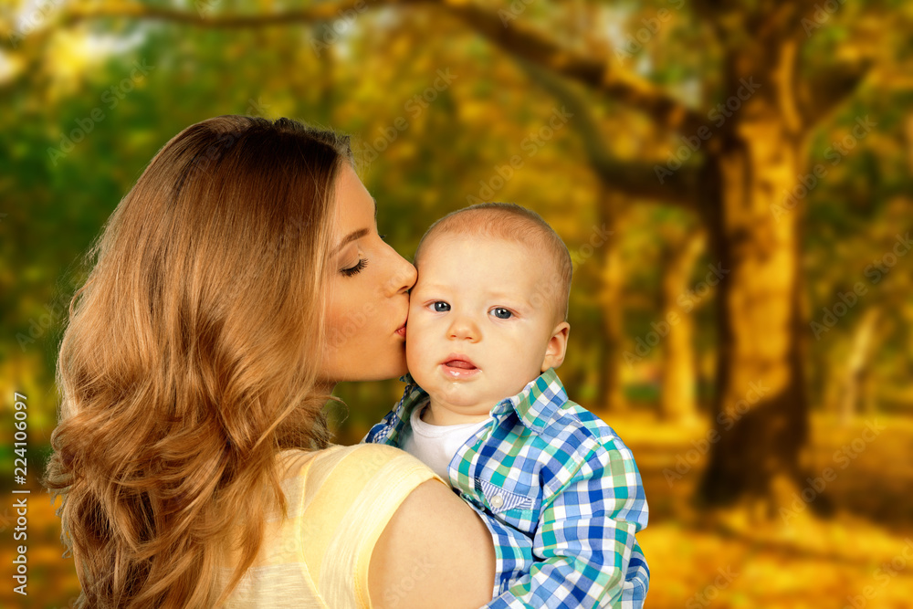 Mother hugging her child during walk in the park Mother hugging her child during walk in the park