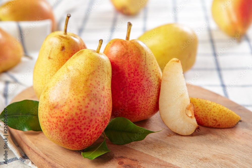 organic pears laying down on a lightly dotted kitchen cloth