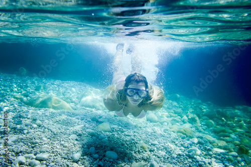 Snorkeling in the tropical sea, woman with mask diving underwater © leszekglasner