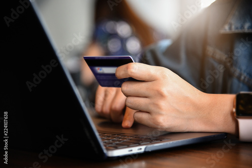Fototapeta Naklejka Na Ścianę i Meble -  Online payment,woman's hands holding credit card and using laptop computer for online shopping. Cyber Monday Concept
