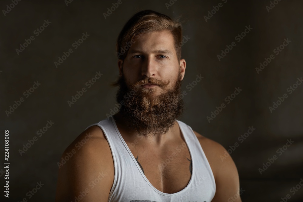 Portrait of a young stylish bearded man