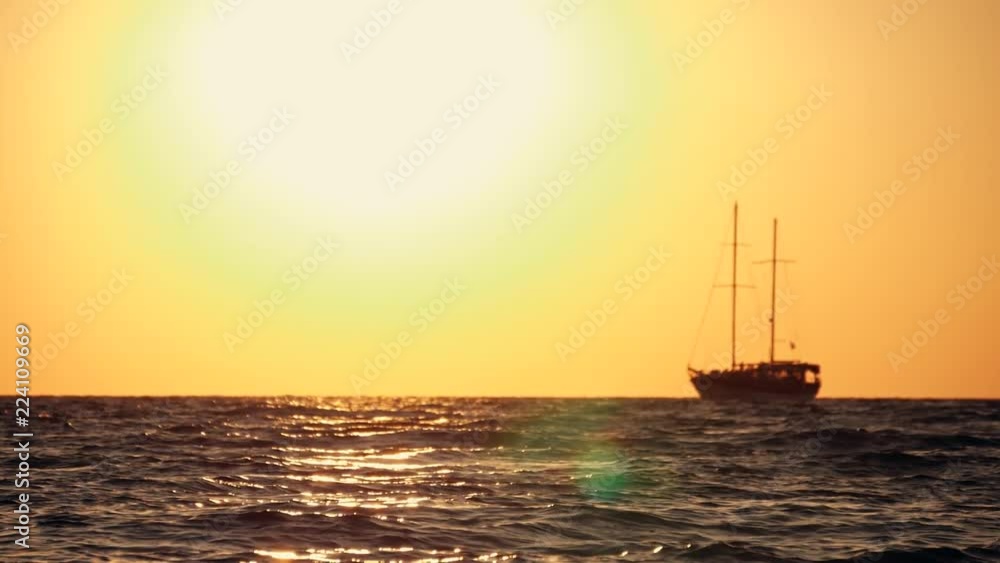 Sailing yacht in the open sea at sunset, rocking on the waves Sailing yacht in the open sea at sunset, rocking on the waves