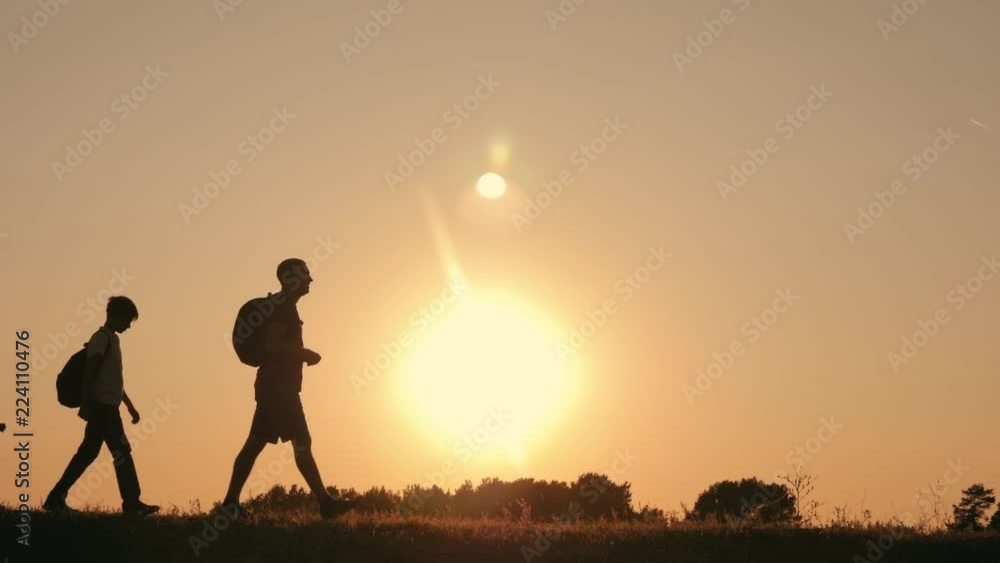 A happy family travels the world. Father and two sons are engaged in outdoor tourism. The concept of a healthy lifestyle and a happy family A happy family travels the world. Father and two sons are engaged in outdoor tourism. The concept of a healthy lifestyle and a happy family