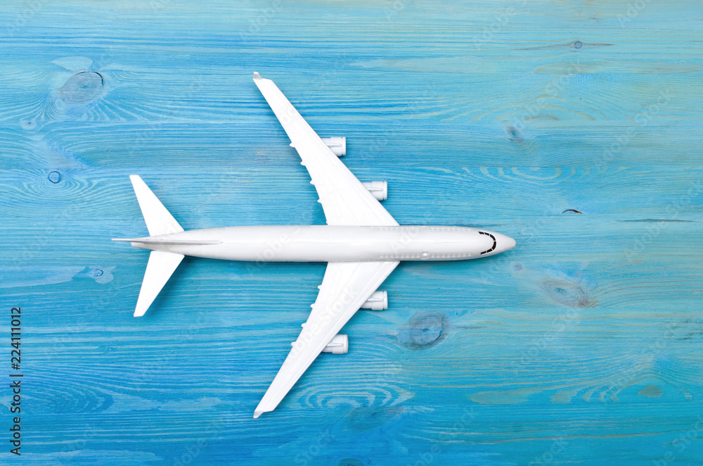 Toy airplane isolated on blue wooden table surface background. Air transportation concept. Toy airplane isolated on blue wooden table surface background. Air transportation concept.
