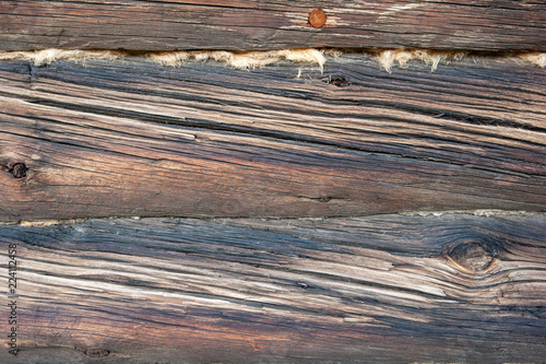 Old timber texture of the log surface of an old traditional wooden house