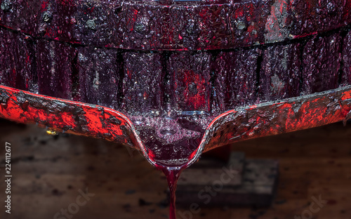Cuadro en lienzo Wooden wine press with red must for pressing grapes to produce wine traditional