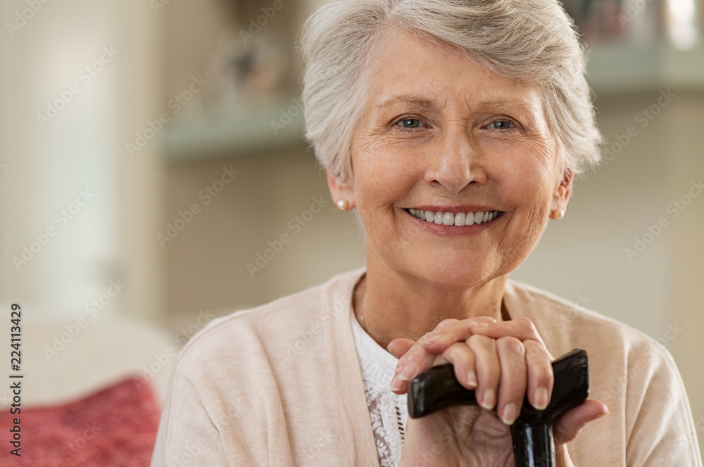 Elderly woman smiling at home - obrazy, fototapety, plakaty 