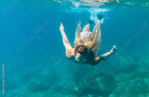 Women diving in the tropical water, snorkeling with mask