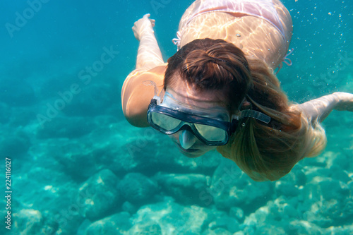 Young woman snorkeling underwater in the tropical sea