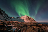 Night winter landscape with Northern lights, Aurora borealis. Scenery view of the Lofoten Islands, Norway