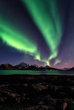 Night winter landscape with Northern lights, Aurora borealis. Scenery view of the Lofoten Islands, Norway. Vertical image