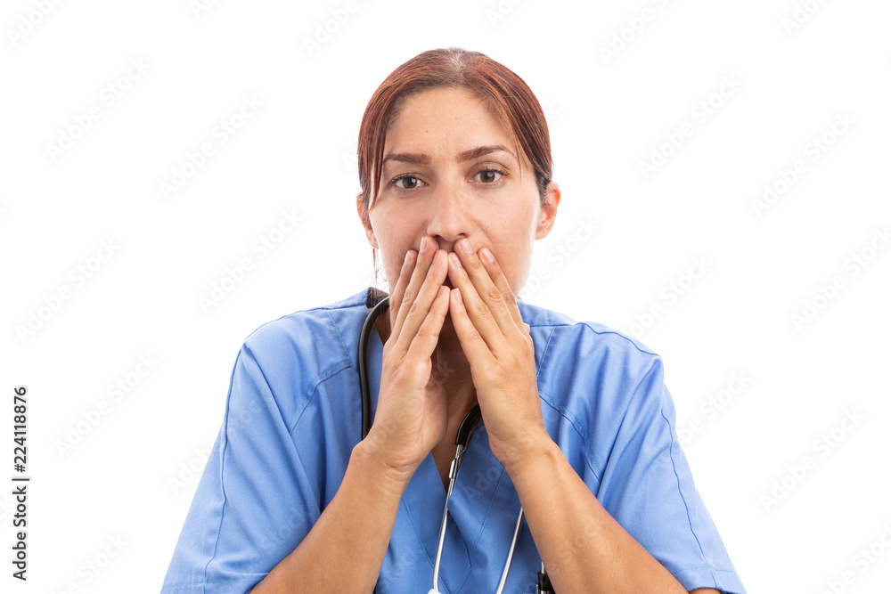 Stressed female nurse or doctor covering her mouth with hands. Stressed female nurse or doctor covering her mouth with hands.