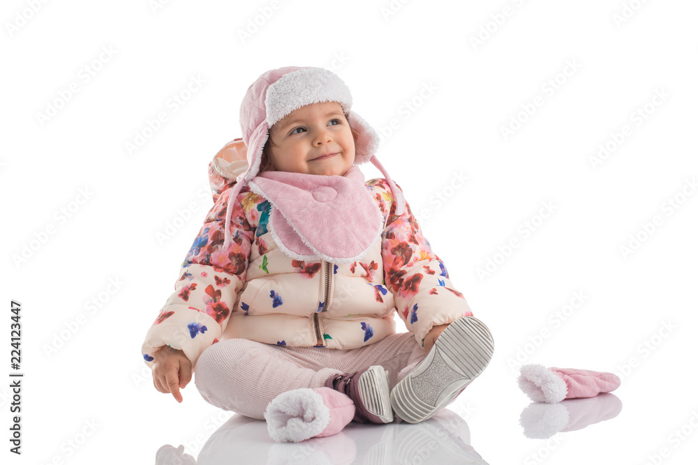 Portrait of happy little baby girl wearing pink winter hat and fluffy coat isolated on white Portrait of happy little baby girl wearing pink winter hat and fluffy coat isolated on white