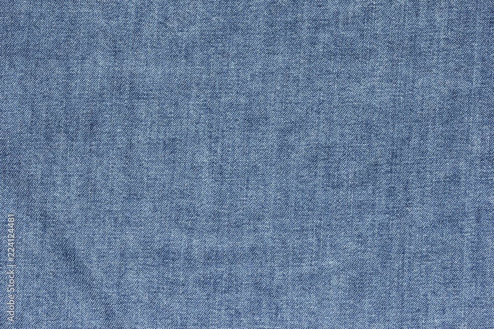 Old blue denim jeans texture or background with visible fibers 