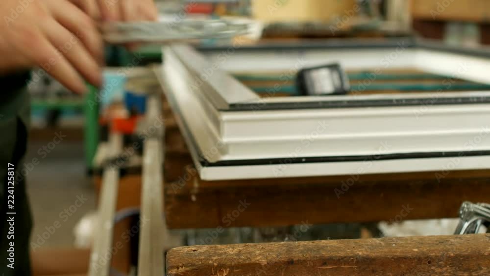 Production and manufacturing of pvc windows, male worker produces pvc window assembly collects sash windows, pvc profile, window assembly Production and manufacturing of pvc windows, male worker produces pvc window assembly collects sash windows, pvc profile, window assembly