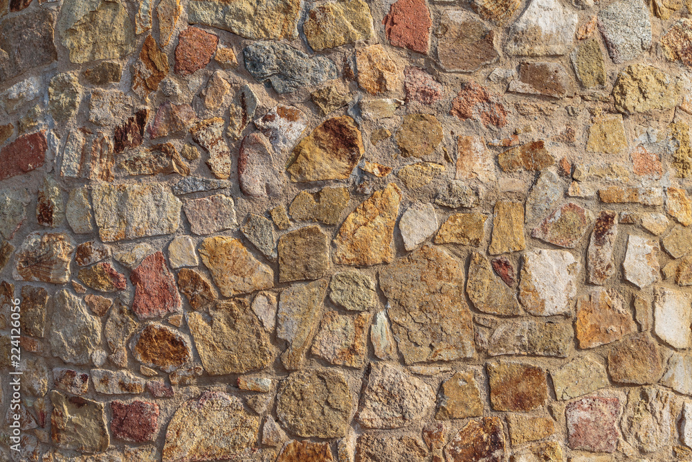 Old beige stone wall background texture close up Old beige stone wall background texture close up
