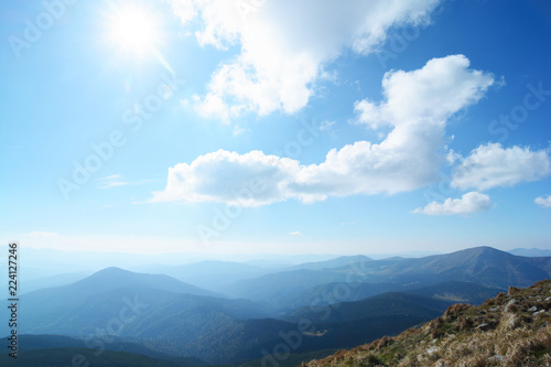 Beautiful dawn against the background of fogs, mountains and hills. Wild nature, travel and recreation. © miztanya