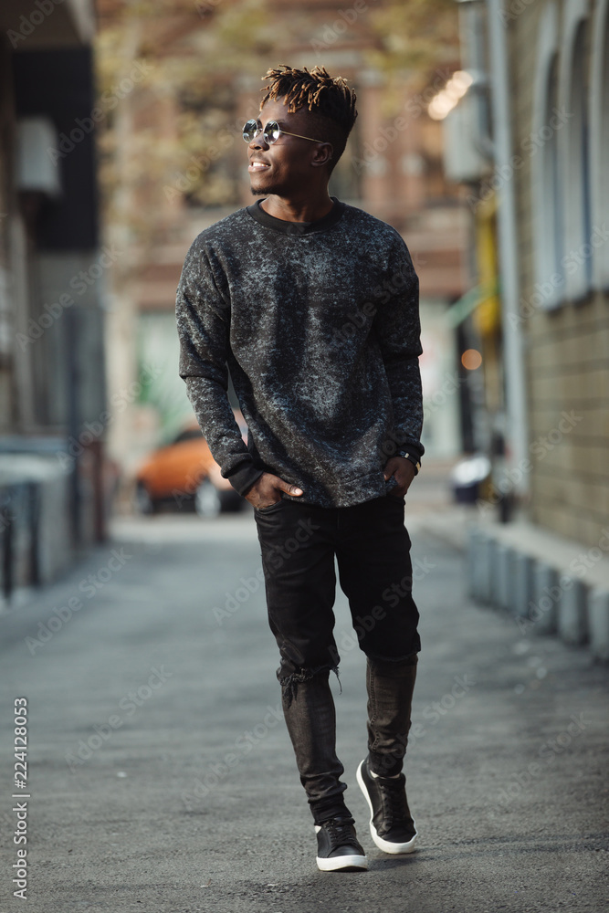 Fashionable cool stylish man wear torn jeans walking in urban territory