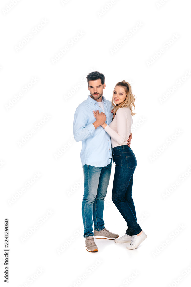 full length view of beautiful happy young couple standing together and smiling at camera isolated on white full length view of beautiful happy young couple standing together and smiling at camera isolated on white