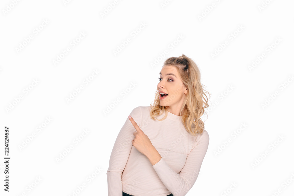 beautiful smiling woman pointing with finger and looking away isolated on white beautiful smiling woman pointing with finger and looking away isolated on white
