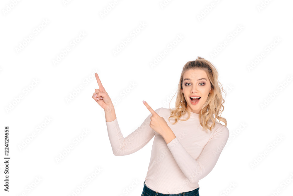beautiful happy girl pointing up with fingers and smiling at camera isolated on white beautiful happy girl pointing up with fingers and smiling at camera isolated on white