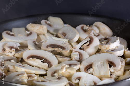 sliced mushrooms in pan ready to cook