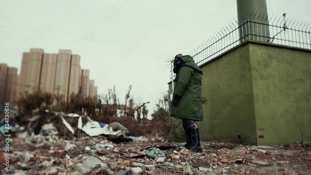 postapocalypse, lonely man walks amid garbage dump and abondoned town postapocalypse, lonely man walks amid garbage dump and abondoned town
