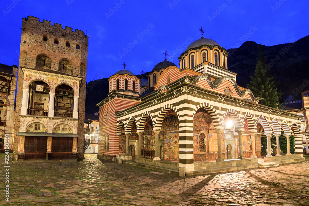 Beautiful view of the Orthodox Rila Monastery, a famous tourist attraction and cultural heritage monument in the Rila Nature Park mountains in Bulgaria in the blue hour at night