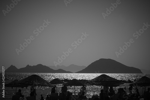 Black and white landscape. People at the resort. Rest on the beach. The coast resorts of the Aegean Sea of Turkey. Turgutreis   Bodrum.