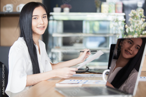 Protrait of Beautiful businesswoman sitting at desk and working with laptop computer.