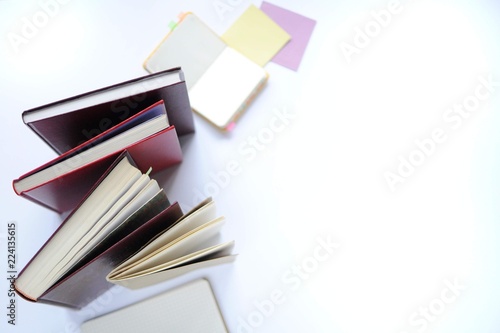 Study stuff. Education background. Stationery. Aspects of education. Books, papers, opened notebook on the table.