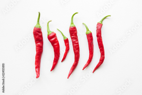 Beautiful red hot chili peppers on white table. Flat lay. Top view.