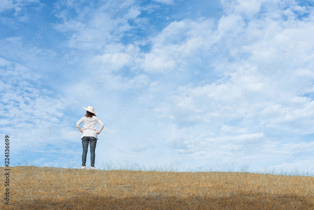 Woman standing on the mountain and looking beautiful sky. Woman standing on the mountain and looking beautiful sky.