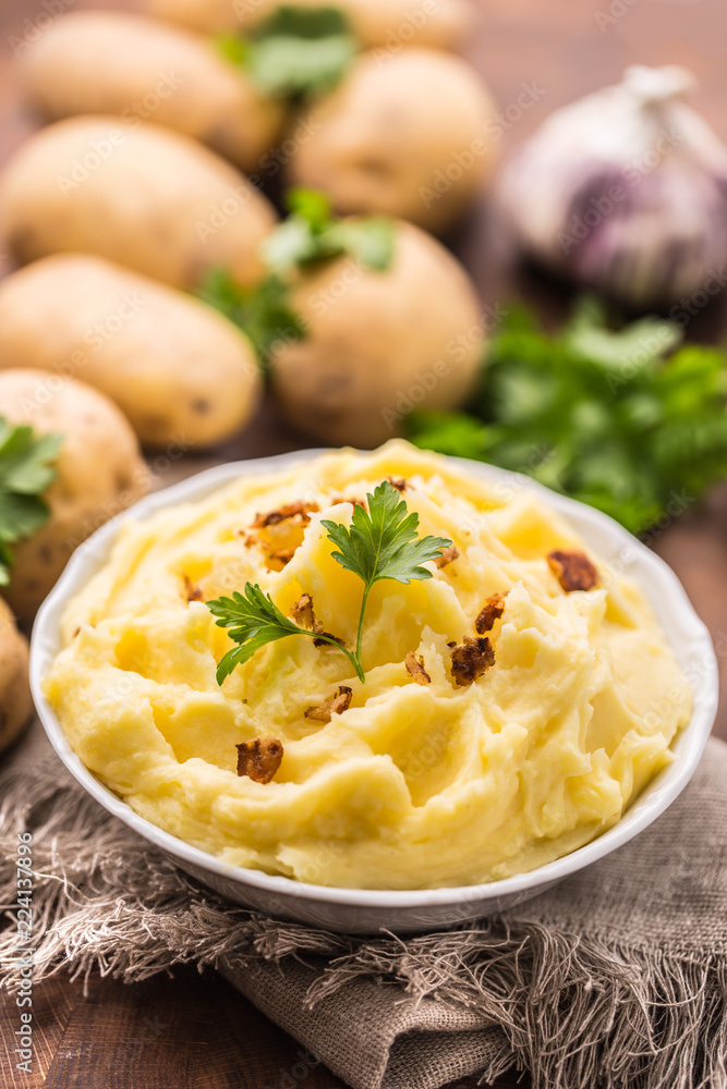 Mashed potatoes in bowl decorated with parsley herbs. Mashed potatoes in bowl decorated with parsley herbs.