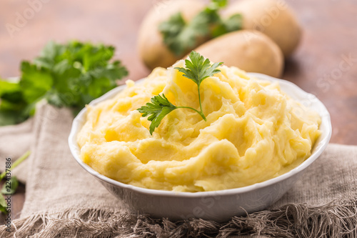 Fotografie Mashed potatoes in bowl decorated with parsley herbs