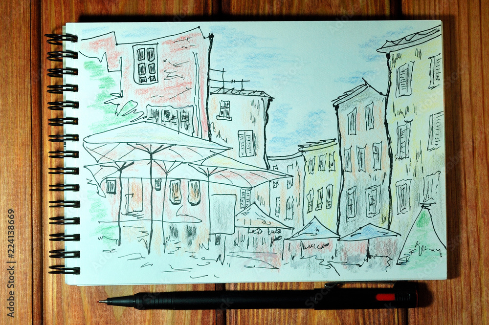 Drawing urban sketch with a liner on wooden background