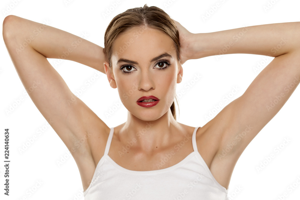 Portrait of young beautiful woman making a ponytail on white backgeound Portrait of young beautiful woman making a ponytail on white backgeound