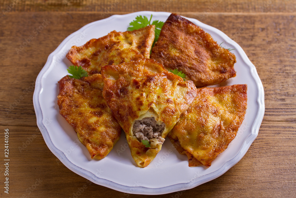 Savory stuffed crepes with meat. Pancakes filled with meat Savory stuffed crepes with meat. Pancakes filled with meat