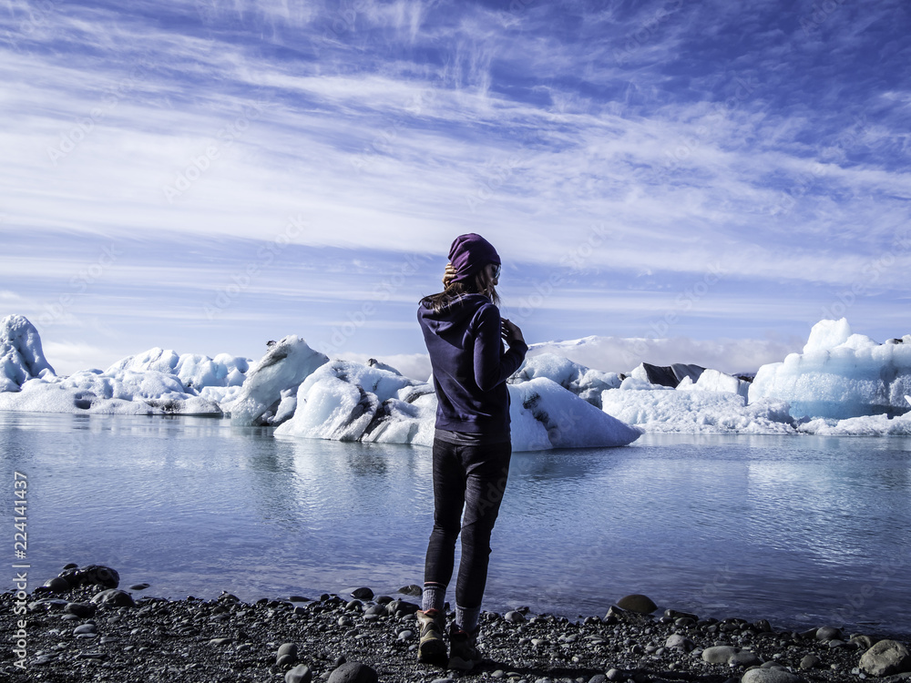Woman enjoying the scenic view of Jokulsarlon Glacier Lagoon in Iceland
