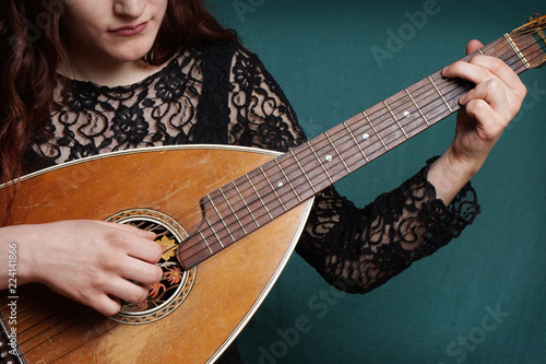 Obraz na plátně close-up of female hands playing old vintage lute string instrument