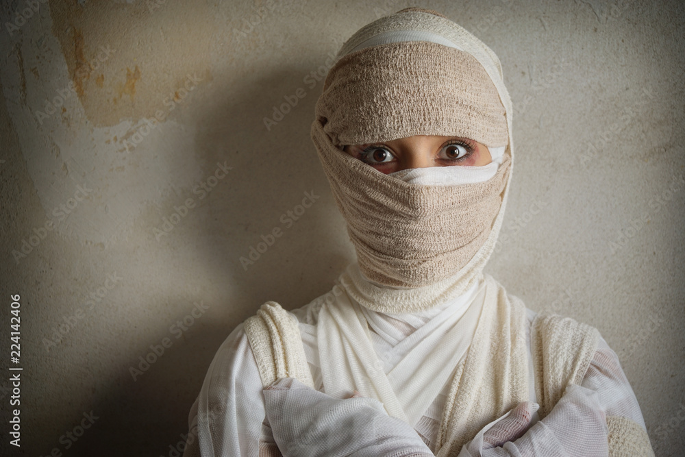 woman wrapped in bandages as egyptian mummy halloween costume Stock Photo |  Adobe Stock
